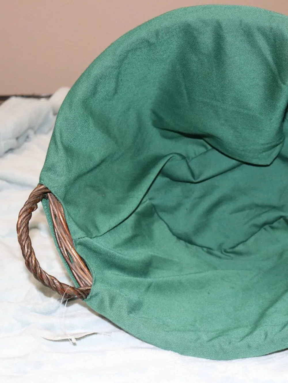 Dark brown circular handle basket with lining.